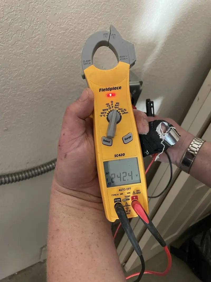 Voltage testing with clamp meter during Outlet Installation in Fair Oaks